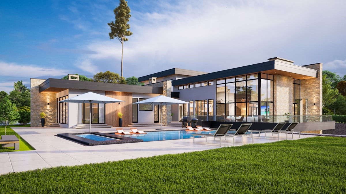 Warmly lit contemporary American home at golden hour with landscaped grounds
