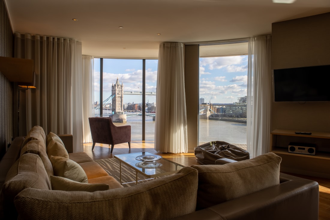 Brooklyn loft interior with curved sofa and bridge views through wide windows