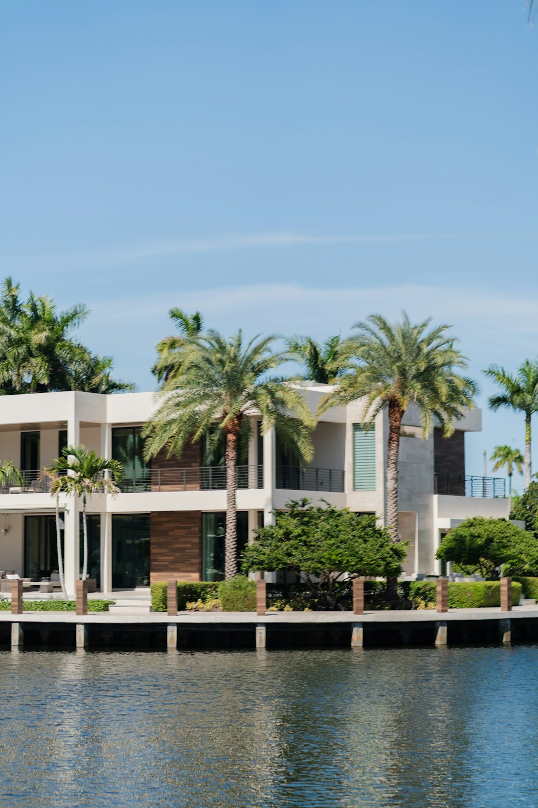 Coconut Grove waterfront residence with palm trees along a private dock